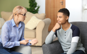 Female psychologist working with teenage boy in office