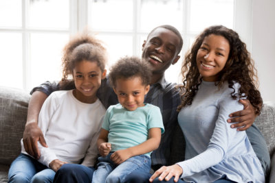 family at home sitting on couch together