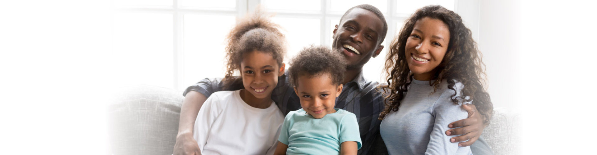 family at home sitting on couch together